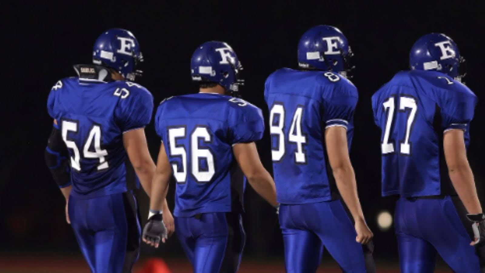 professional American football players wearing royal blue jerseys