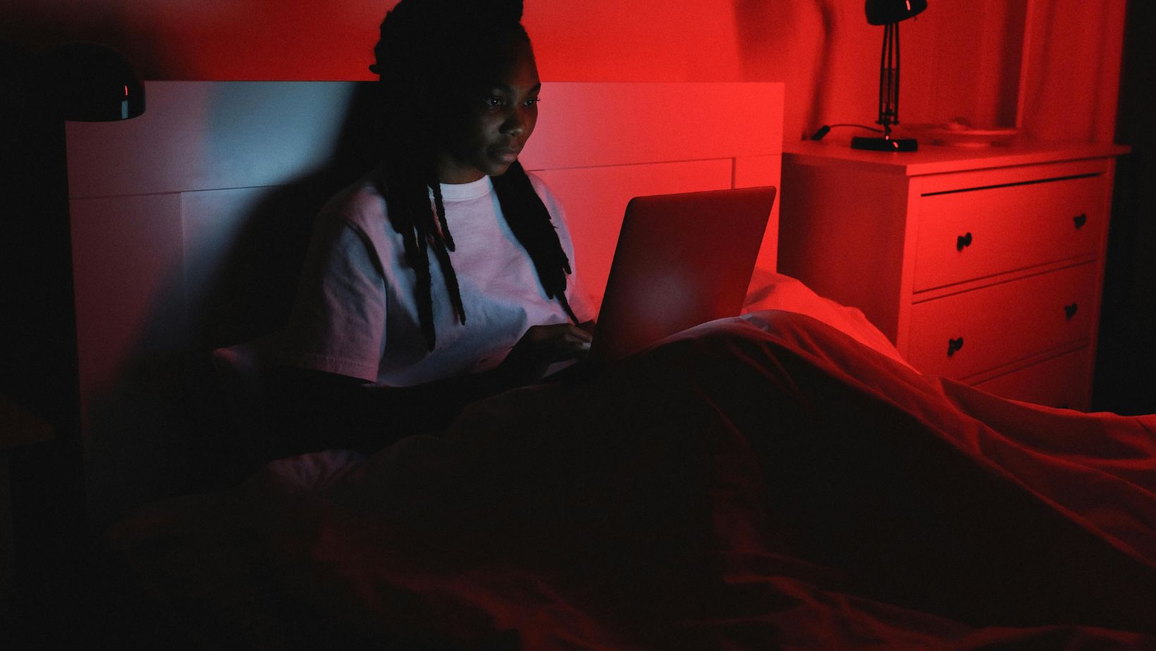 a woman using her laptop at night
